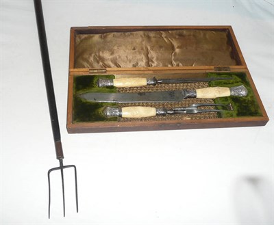 Lot 395 - A carved bone silver-mounted three piece carving set and a toasting fork