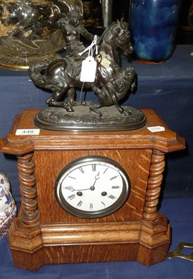 Lot 448 - Oak cased mantel clock with figural mount and key