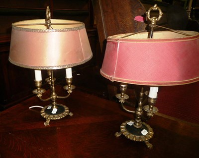 Lot 450 - A pair of brass three branch lamps