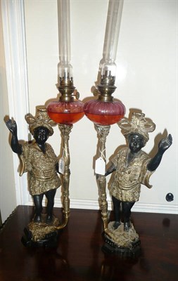 Lot 460 - A pair of gilt metal Blackamoor oil lamps