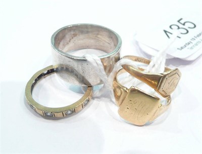 Lot 485 - A signet ring stamped '18CT', a 9ct gold signet ring, a silver band ring and a stone set ring (4)