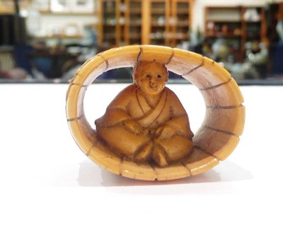 Lot 491 - A Japanese ivory netsuke as a lady in a barrel, circa 1900