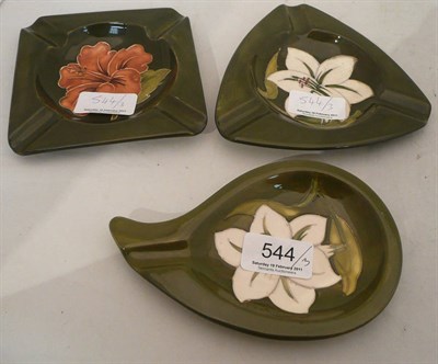 Lot 544 - Three Walter Moorcroft ashtrays on green grounds