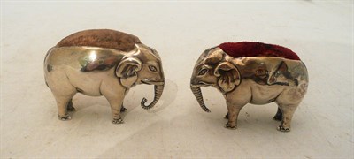 Lot 588 - Two large silver elephant pin cushions