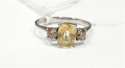 Lot 595 - A 14ct white gold yellow sapphire and diamond ring