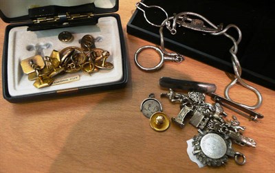 Lot 604 - A 22ct gold band ring, assorted dress studs and buttons, a 9ct cufflink and a silver charm bracelet