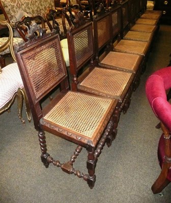 Lot 854 - A set of nine carved oak dining chairs with cane seats