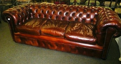 Lot 861 - A brown leather Chesterfield settee