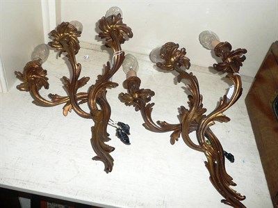 Lot 907 - Set of four three branch gilt metal wall lights