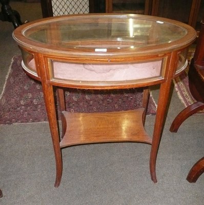 Lot 914 - An Edwardian satinwood oval table-top glazed display cabinet