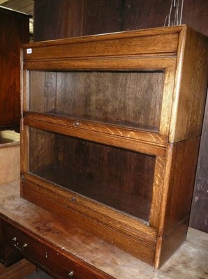 Lot 952 - An oak two section bookcase