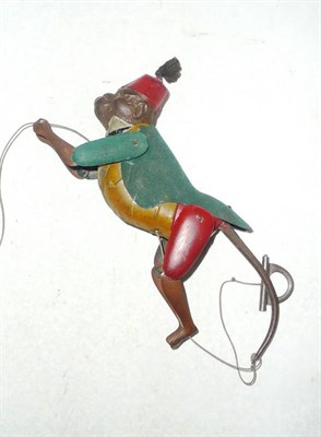 Lot 1041 - A Tinplate Climbing Monkey Toy, wearing a red fez, green felt jacket, yellow waistcoat and red...