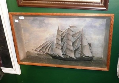 Lot 1541 - A framed picture of a ship in a glazed mount, Whitby in the background