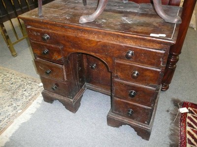 Lot 1622 - An 18th century burr elm kneehole writing desk with later knobs and bracket feet (woodworm,...