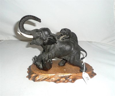 Lot 23 - A Japanese bronze Meiji period elephant with tigers, wood base