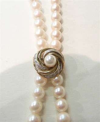 Lot 74 - A strand of cultured pearls with a 9ct gold diamond-set adjuster snap