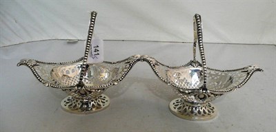Lot 141 - Pair of pierced silver baskets with swing handles