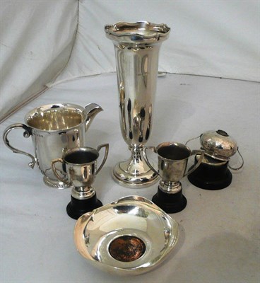 Lot 144 - Silver spill vase, silver jug, a silver dish with coin inset, and three small plated trophy...