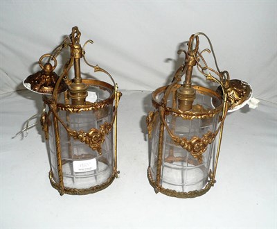 Lot 192 - A pair of gilt metal and cut glass lanterns
