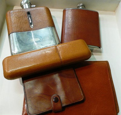 Lot 238 - Two plate and leather flasks, a cigar holder and three wallets