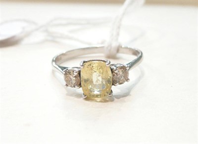 Lot 257 - A 14ct white gold yellow sapphire and diamond ring