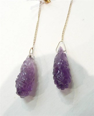 Lot 265 - A pair of carved amethyst drop earrings