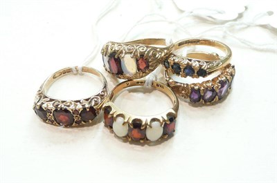 Lot 267 - A 9ct gold amethyst ring, a 9ct gold sapphire ring, a 9ct gold garnet ring, and two 9ct gold garnet