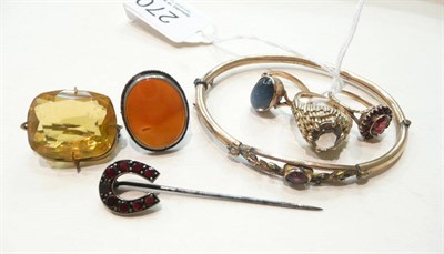 Lot 270 - A garnet stick pin, a bangle, a brooch and four rings