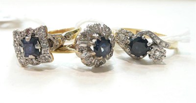 Lot 295 - Two sapphire and diamond cluster rings and a sapphire and diamond three stone ring