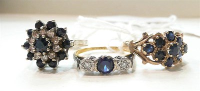 Lot 297 - Two sapphire cluster rings and a three stone ring