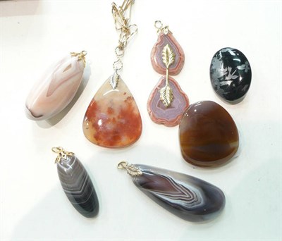 Lot 301 - A moss agate pendant on chain, four agate pendants and two brooches