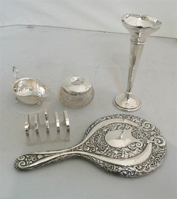 Lot 311 - Silver backed dressing mirror, a toast rack, sauce boat, trumpet vase and hair tidy