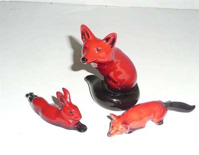 Lot 319 - Two Doulton flambe foxes and a hare