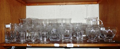 Lot 335 - Quantity of cut and other drinking glasses and a water jug on a shelf