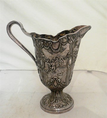 Lot 353 - A large Continental white metal jug with repousse decoration of figures