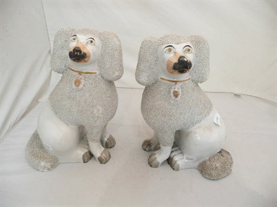 Lot 360 - A pair of Staffordshire spaniels with lion cut manes (a.f.)