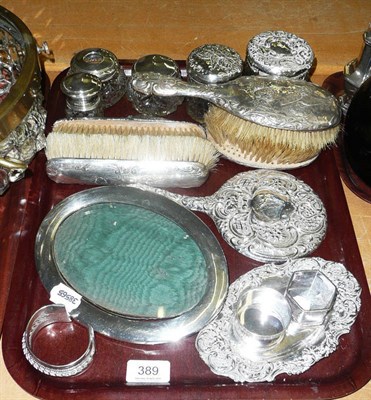 Lot 389 - Silver backed dressing table items, silver photograph frame, silver topped jars, silver napkin...