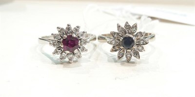 Lot 402 - A ruby and diamond cluster ring stamped '18CT', and a sapphire and diamond cluster ring stamped...