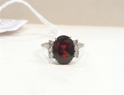 Lot 410 - A 14ct white gold garnet and diamond ring