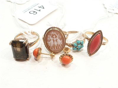 Lot 416 - A turquoise cluster ring, a smokey quartz ring, a coral ring, a shell cameo ring, and a pair of...