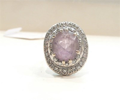 Lot 422 - An amethyst and diamond cluster ring stamped '18CT'