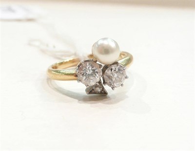 Lot 442 - A three stone diamond and pearl ring