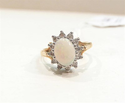 Lot 443 - An opal and diamond cluster ring stamped '18CT'