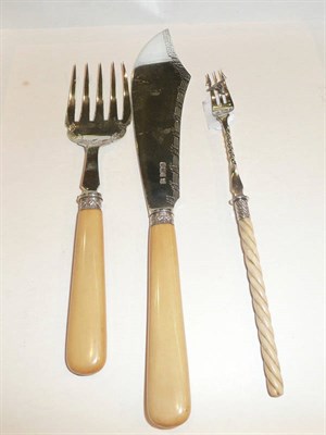 Lot 451 - A pair of ivory-handled silver fish servers and a pickle fork with turned ivory handle