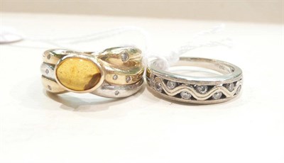 Lot 455 - A diamond set ring stamped '750' and an amber and diamond two colour ring (2)