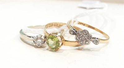 Lot 456 - A 9ct white gold diamond solitaire ring, an 18ct gold peridot ring and a diamond cluster ring