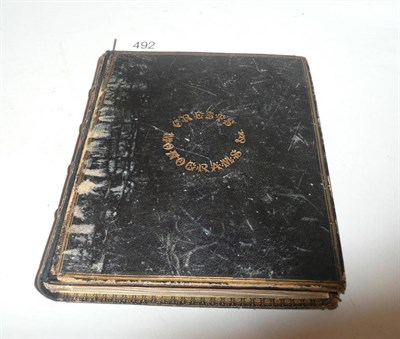 Lot 492 - A leather-bound album containing an extensive collection of crests