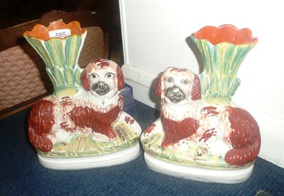 Lot 585 - A pair of Staffordshire pottery Spaniel spill vases, circa 1870, the recumbent animals with...