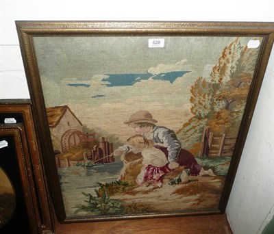 Lot 628 - Large framed woolwork picture of two children fishing by a water mill, 62 cms by 73 cms.