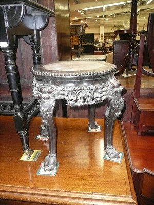 Lot 725 - Two Chinese hardwood urn stands with inset marble top, on four carved supports